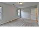 Bedroom featuring bright neutral walls, carpet flooring, and a large window at 1915 Turtle Creek Way, Lawrenceville, GA 30043