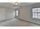 Bright bedroom featuring two large windows, neutral walls, and plush neutral carpeting at 1915 Turtle Creek Way, Lawrenceville, GA 30043