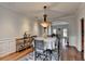 Elegant dining room with hardwood floors, crown molding, and a stylish chandelier at 1915 Turtle Creek Way, Lawrenceville, GA 30043