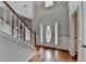 Bright foyer with gleaming hardwood floors, a staircase with white risers, and decorative trim at 1915 Turtle Creek Way, Lawrenceville, GA 30043