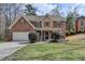 Charming brick two-story home with a manicured lawn and inviting covered front porch at 1915 Turtle Creek Way, Lawrenceville, GA 30043