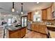 Bright kitchen features wooden cabinets, stainless steel appliances, granite countertops, and an island with bar seating at 1915 Turtle Creek Way, Lawrenceville, GA 30043