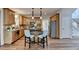 Bright kitchen features wooden cabinets, stainless steel appliances, granite countertops, tile backsplash, and island with seating at 1915 Turtle Creek Way, Lawrenceville, GA 30043