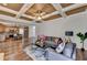 Inviting living room features a coffered ceiling, open access to the kitchen and hardwood floors at 1915 Turtle Creek Way, Lawrenceville, GA 30043