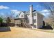 Spacious backyard featuring a well-maintained lawn, patio, fence line, and the home's exterior at 918 Fox Hollow Way, Marietta, GA 30068