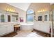 Elegant bathroom with a soaking tub, a large window, and dual vanities with great lighting at 918 Fox Hollow Way, Marietta, GA 30068