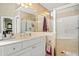 Bathroom with a vanity, glass enclosed shower, and gold hardware at 918 Fox Hollow Way, Marietta, GA 30068