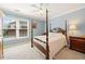 Bedroom featuring a four-poster bed, side table, and window providing natural light at 918 Fox Hollow Way, Marietta, GA 30068