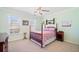 Bedroom with pale green walls, carpet floors, two sunny windows, and dark wood furnishings at 918 Fox Hollow Way, Marietta, GA 30068