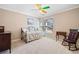 Cozy bedroom with neutral walls, ceiling fan with colorful blades, a daybed, and bright window views at 918 Fox Hollow Way, Marietta, GA 30068