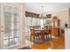 Bright dining area showcasing natural light from the large window, and classic wooden dining set at 918 Fox Hollow Way, Marietta, GA 30068