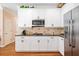Well-equipped kitchen with stainless steel appliances, white cabinets, and a tile backsplash at 918 Fox Hollow Way, Marietta, GA 30068