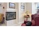 A living room nook features a cozy tile fireplace, art, and a side table with a lamp at 918 Fox Hollow Way, Marietta, GA 30068