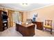 Home office space with a large desk, elegant curtains, wood floors and ample room for productivity at 918 Fox Hollow Way, Marietta, GA 30068