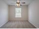 Clean bedroom featuring neutral walls, carpet, ceiling fan, and a large window at 966 Westmoreland Nw Cir, Atlanta, GA 30318
