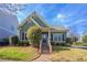 Charming green home featuring a landscaped front yard, brick walkway and inviting entrance at 966 Westmoreland Nw Cir, Atlanta, GA 30318