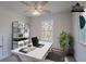 This home office offers a tranquil workspace with a bright window and ceiling fan at 966 Westmoreland Nw Cir, Atlanta, GA 30318