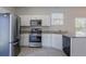 Bright kitchen featuring stainless steel appliances, white cabinetry, and granite countertops at 966 Westmoreland Nw Cir, Atlanta, GA 30318