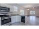 Open kitchen with modern appliances and granite countertops, flowing into a spacious living area at 966 Westmoreland Nw Cir, Atlanta, GA 30318
