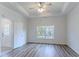Spacious main bedroom with a tray ceiling, ceiling fan, and large windows at 966 Westmoreland Nw Cir, Atlanta, GA 30318