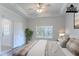 Virtually staged primary bedroom with a tray ceiling, fan, and ample natural light at 966 Westmoreland Nw Cir, Atlanta, GA 30318