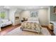 Bright bedroom with hardwood floors, natural light, neutral colors, and cozy decor at 160 Peachtree Ne Way, Atlanta, GA 30305