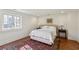 This bright bedroom offers hardwood floors, a window, and an area rug at 160 Peachtree Ne Way, Atlanta, GA 30305