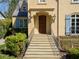 Inviting exterior with a stone staircase, charming shutters, and manicured landscaping at 160 Peachtree Ne Way, Atlanta, GA 30305