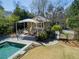 A pool house and patio area compliment the lovely pool and outdoor entertainment space at 160 Peachtree Ne Way, Atlanta, GA 30305