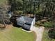 Aerial view showcasing the home's layout, expansive yard, and surrounding trees at 513 S Malton Ct, Stone Mountain, GA 30083