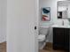 View of a renovated half bathroom featuring dark vanity and quartz countertop at 513 S Malton Ct, Stone Mountain, GA 30083