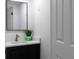 Modern half bathroom featuring dark vanity and quartz countertop at 513 S Malton Ct, Stone Mountain, GA 30083