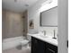 Modern bathroom with a tub, shower, and sleek black vanity at 513 S Malton Ct, Stone Mountain, GA 30083