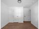 A well-lit bedroom showcasing its light wood flooring, fresh paint, and doors at 513 S Malton Ct, Stone Mountain, GA 30083