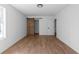 Bright bedroom with light wood floor, white walls and ceiling, window, and barn door at 513 S Malton Ct, Stone Mountain, GA 30083