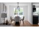 Dining room features modern chandelier, neutral colors and a large window at 513 S Malton Ct, Stone Mountain, GA 30083