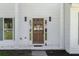 Inviting home entrance featuring a beautifully crafted wooden door and stylish exterior lighting at 513 S Malton Ct, Stone Mountain, GA 30083