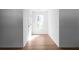 Bright hallway with wood floors, fresh paint, and natural light streaming through the window at 513 S Malton Ct, Stone Mountain, GA 30083