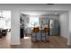 Open kitchen area with stainless appliances, breakfast bar, gray cabinets, and wood floors at 513 S Malton Ct, Stone Mountain, GA 30083