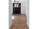 Open-concept living room featuring a black brick fireplace and wood flooring at 513 S Malton Ct, Stone Mountain, GA 30083