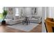 Bright living room featuring hardwood floors, large windows, and views into the dining area at 513 S Malton Ct, Stone Mountain, GA 30083