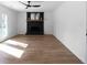 Spacious living room with black fireplace, ceiling fan, and door leading to outside at 513 S Malton Ct, Stone Mountain, GA 30083