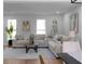 Open-concept living room with hardwood floors and lots of natural light at 513 S Malton Ct, Stone Mountain, GA 30083