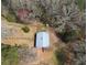 Aerial view showing the barn on the property nestled among trees, offering privacy at 75 Price Dr, Locust Grove, GA 30248