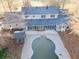 An aerial view of the house with a grey roof, white trim and a pool in the back at 75 Price Dr, Locust Grove, GA 30248