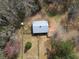 Aerial view showing the barn surrounded by tall trees at 75 Price Dr, Locust Grove, GA 30248