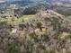 Aerial view showing the house, barn, and yard at 75 Price Dr, Locust Grove, GA 30248