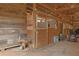 Barn interior featuring horse stalls crafted with wood and metal at 75 Price Dr, Locust Grove, GA 30248