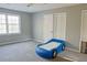 Bright bedroom with neutral walls, carpeted floor and a blue car shaped bed at 75 Price Dr, Locust Grove, GA 30248
