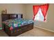 Cozy bedroom with a dark wood bed frame and red curtains at 75 Price Dr, Locust Grove, GA 30248